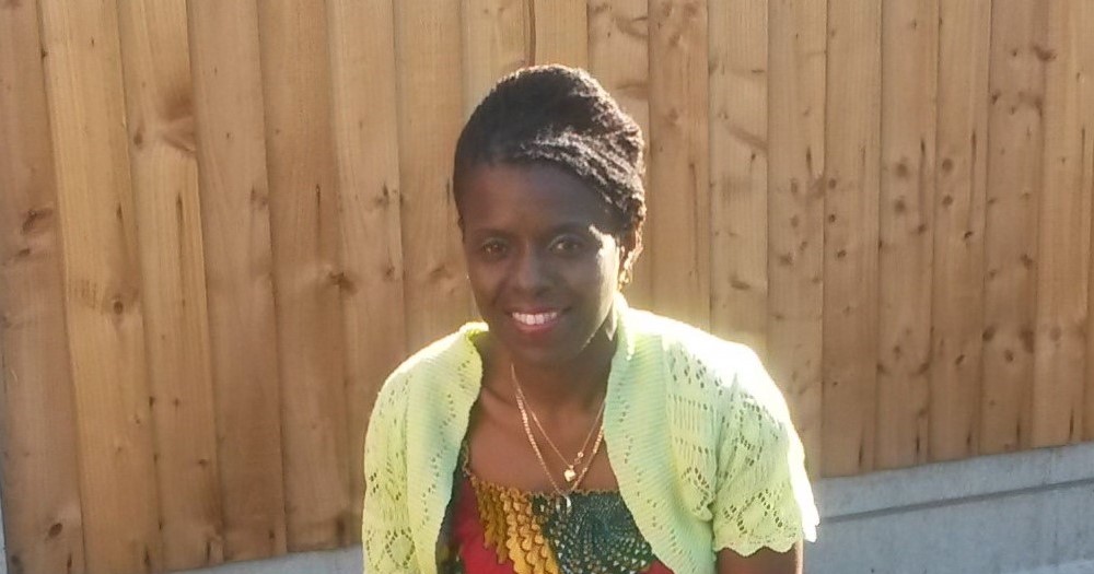 Black smiling lady, Beehive hair, lime short cardigan, and necklaces